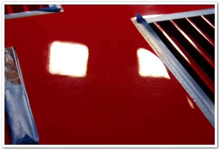 50/50 shot of a rear deck lid polished with Menzerna SIP and an orange pad on a Ferrari 288 GTO