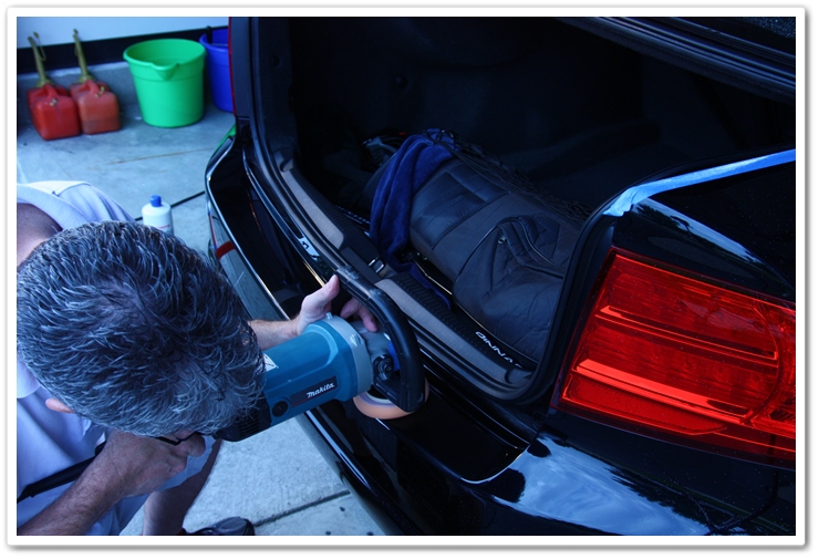 Polishing the lower bumper of an Acura TL in NBP with the trunk open