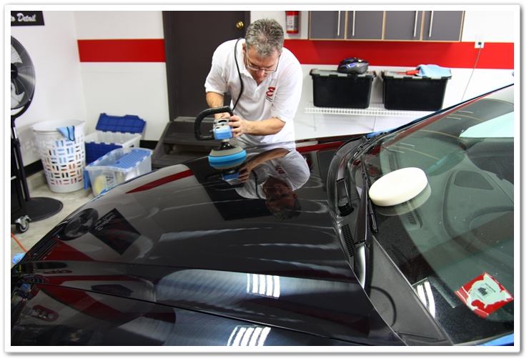 Polishing the hood of an Acura TL with Menzerna PO85RD and a blue Lake Country pad on a Makita rotary
