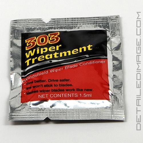 Foggy residue on windshield after wipers blades wipe away water.