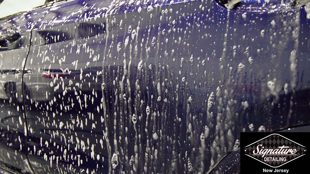 Car Wash foam applied to a vehicle during a traditional car wash by Signature Detailing NJ