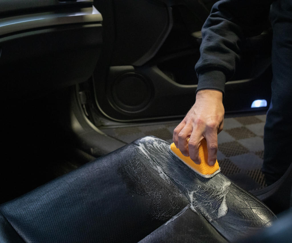 Image scrugging BMW leather seat with AutofiberScrub Ninja