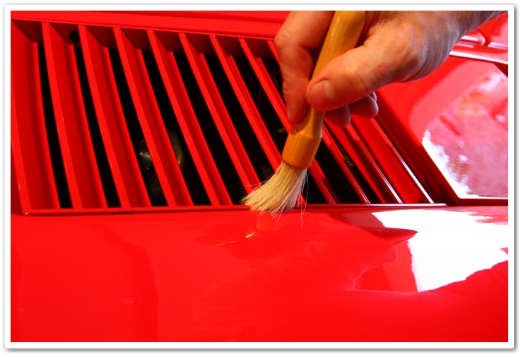 Cleaning out polishing residue on a 1985 Ferrari 288 GTO with a boars hair brush