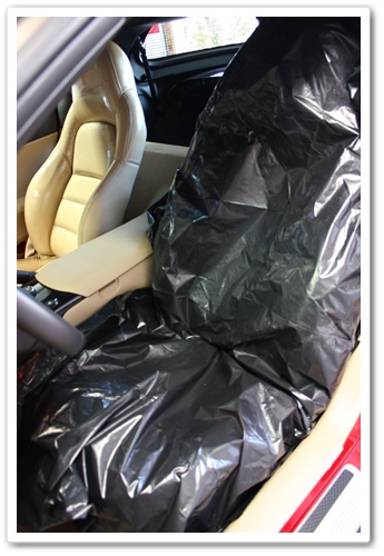 Chevy Corvette leather seat covered in plastic to allow Leatherique Rejuvenator Oil to penetrate the leather