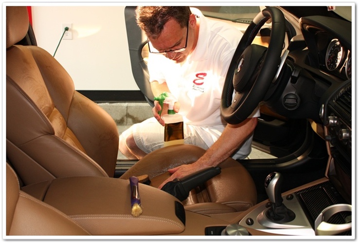 Massaging Leatherique Prestine Clean into BMW M6 leather with bare hands