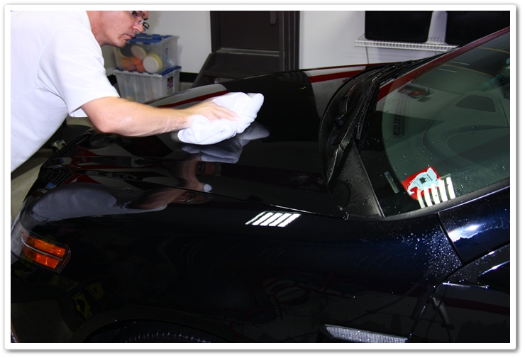 Wiping off Optimum Instant Detailer on the hood of an Acura TL