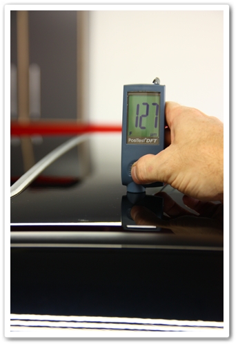 Taking measurement of the thickness of paint on a 2007 NBP Acura TL