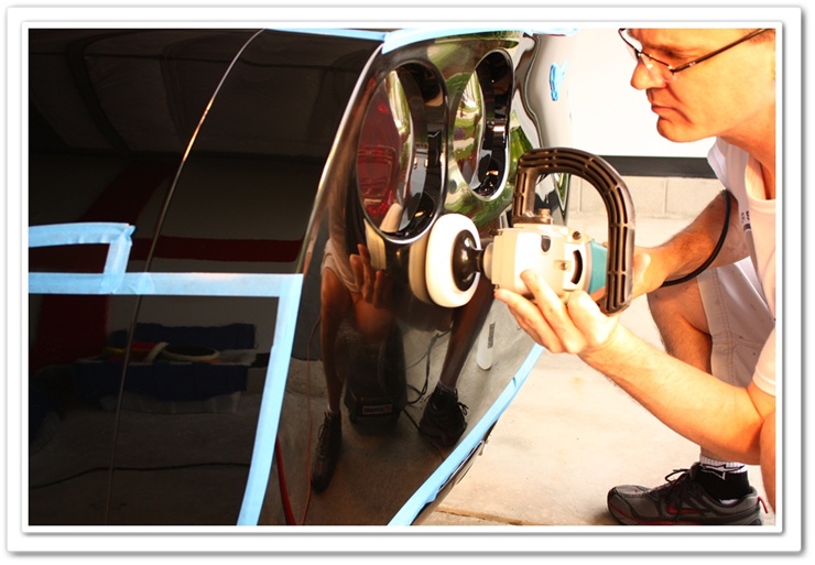 Polishing a 2008 black Chevy Corvette with a white polishing pad and Makita buffer